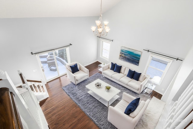 living room with dark hardwood / wood-style floors, high vaulted ceiling, and a notable chandelier