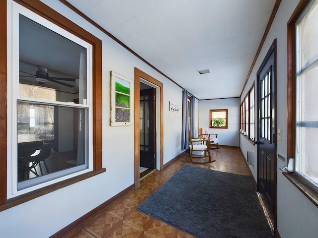 hallway with crown molding and dark parquet floors