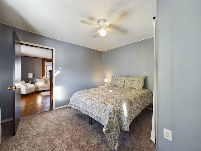 bedroom featuring ceiling fan and dark carpet