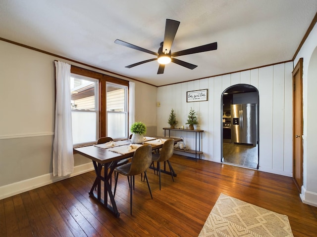 dining space with ceiling fan, dark hardwood / wood-style flooring, and crown molding