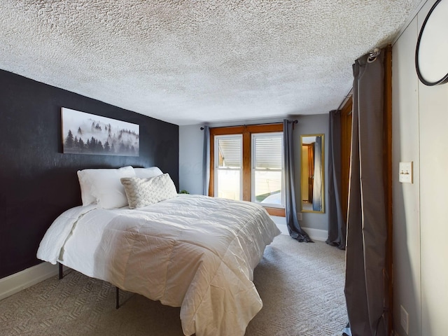 carpeted bedroom featuring a textured ceiling