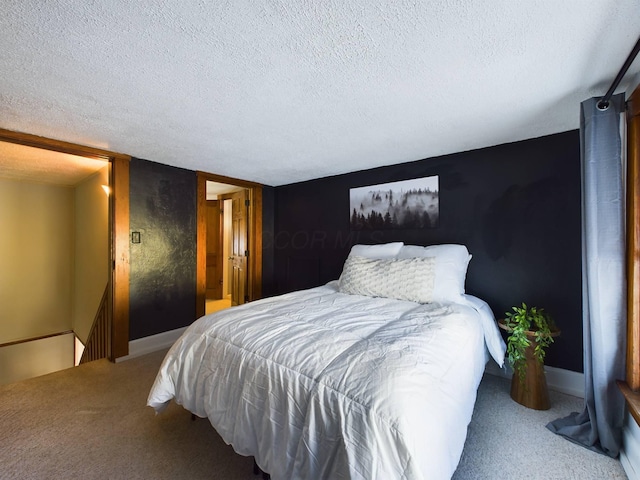 bedroom with a textured ceiling and carpet flooring