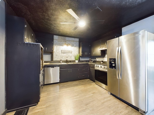 kitchen featuring light wood-type flooring, ceiling fan, appliances with stainless steel finishes, and sink