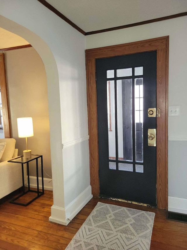 entryway featuring hardwood / wood-style flooring and ornamental molding