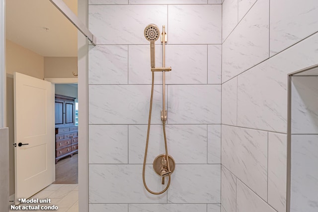 interior details featuring tiled shower