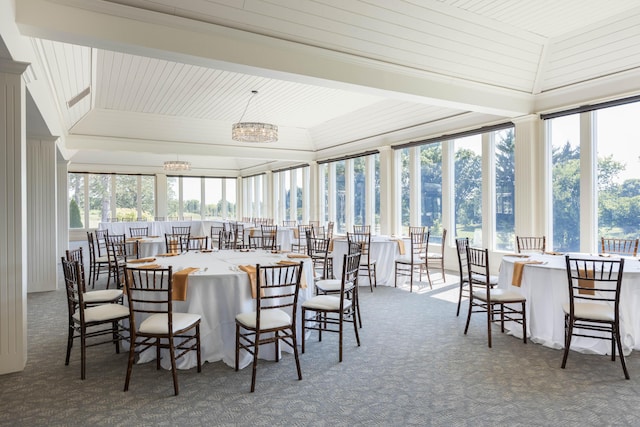 sunroom featuring a notable chandelier