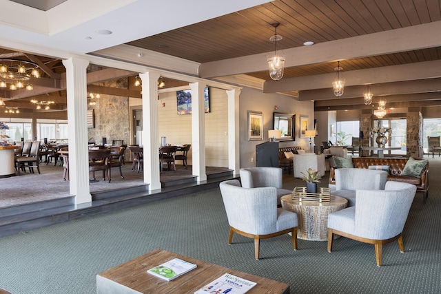 carpeted living room featuring beam ceiling, plenty of natural light, ornate columns, and wood ceiling