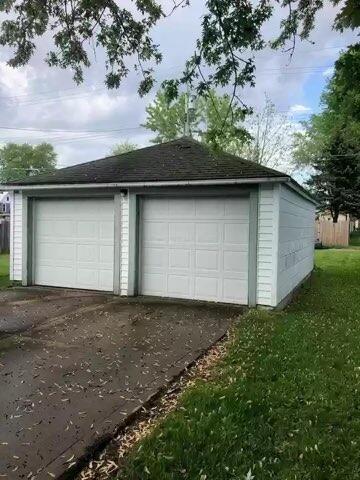 garage featuring a lawn