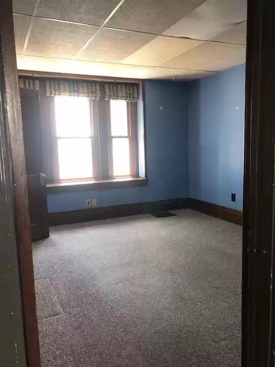 spare room featuring a paneled ceiling