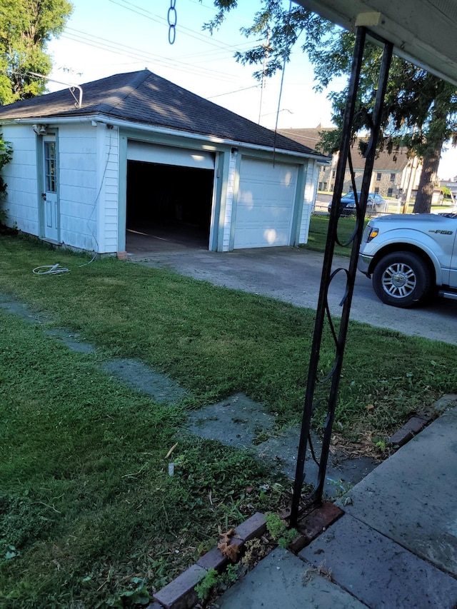 garage featuring a lawn