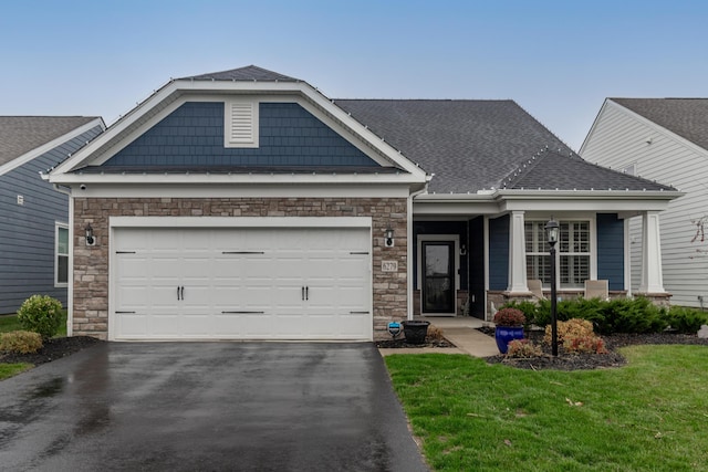 craftsman-style home with a front lawn and a garage