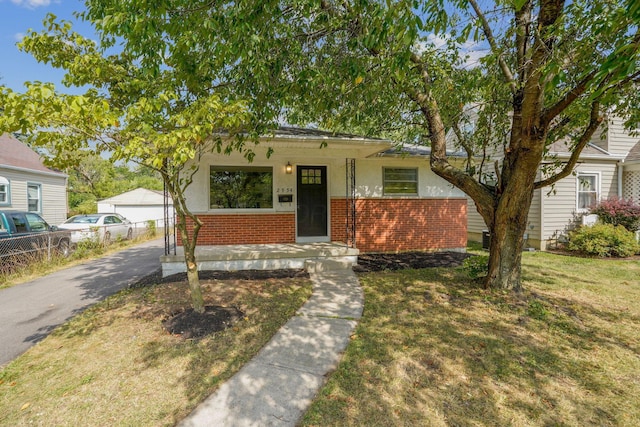 bungalow-style home featuring a front yard