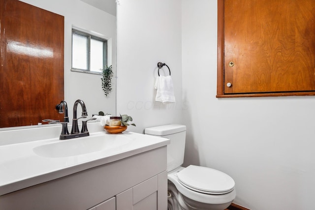 bathroom with toilet and vanity