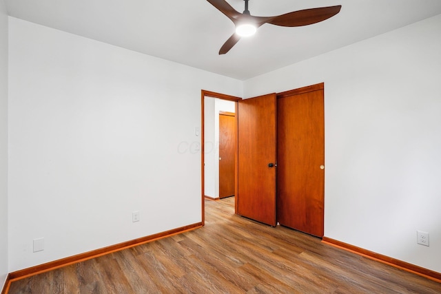 unfurnished bedroom with ceiling fan, a closet, and light wood-type flooring