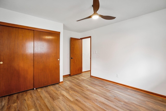 unfurnished bedroom with a closet, light hardwood / wood-style floors, and ceiling fan