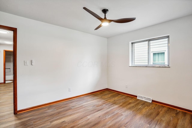 unfurnished room with ceiling fan and hardwood / wood-style flooring