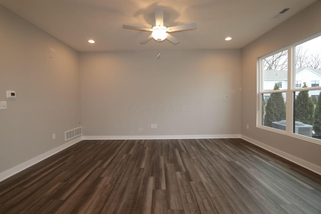 spare room with ceiling fan and dark wood-type flooring