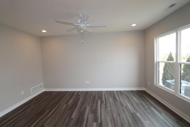 spare room featuring dark hardwood / wood-style floors and ceiling fan