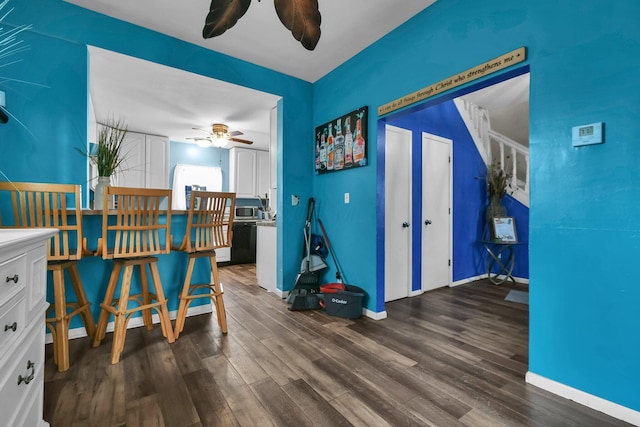 interior space featuring ceiling fan and dark hardwood / wood-style flooring