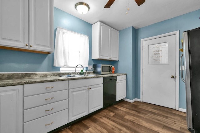 kitchen featuring dark hardwood / wood-style floors, stainless steel appliances, white cabinets, and sink