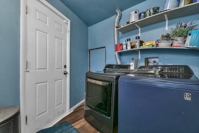 laundry room featuring washer and dryer and dark hardwood / wood-style flooring