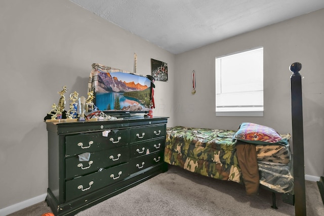 carpeted bedroom featuring a textured ceiling