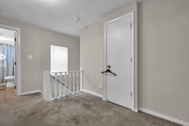 hallway with carpet floors