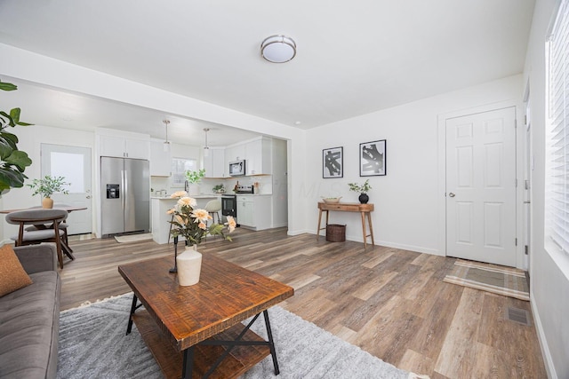 living room with light hardwood / wood-style flooring