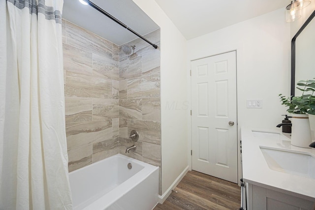 bathroom featuring hardwood / wood-style floors, vanity, and shower / bath combo