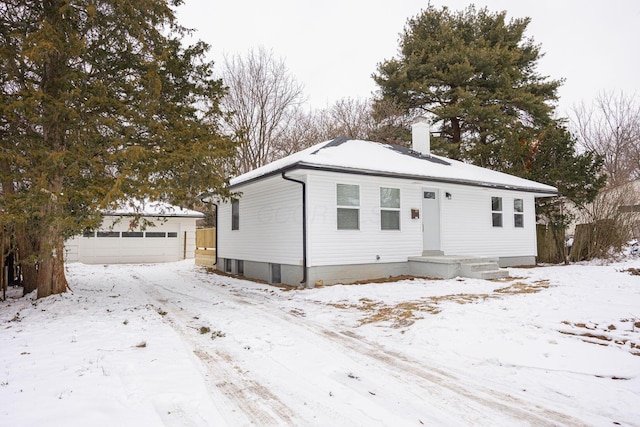 view of front facade with an outdoor structure and a garage