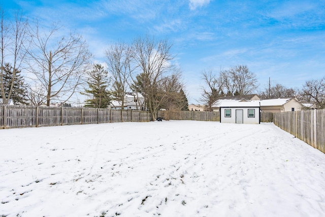 yard covered in snow featuring an outbuilding