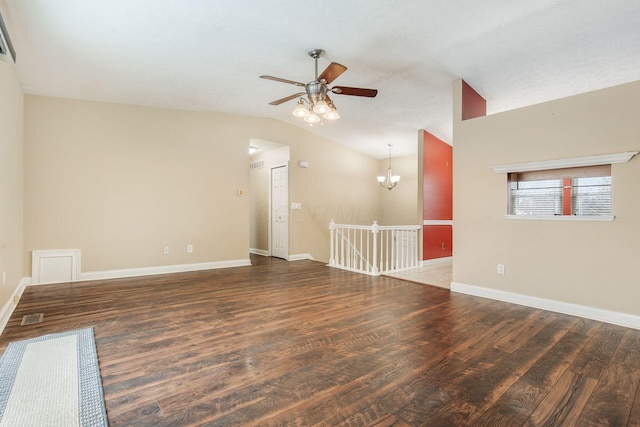 unfurnished room featuring vaulted ceiling, dark wood-type flooring, and ceiling fan with notable chandelier