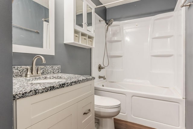 full bathroom with toilet, vanity, bathing tub / shower combination, and hardwood / wood-style floors