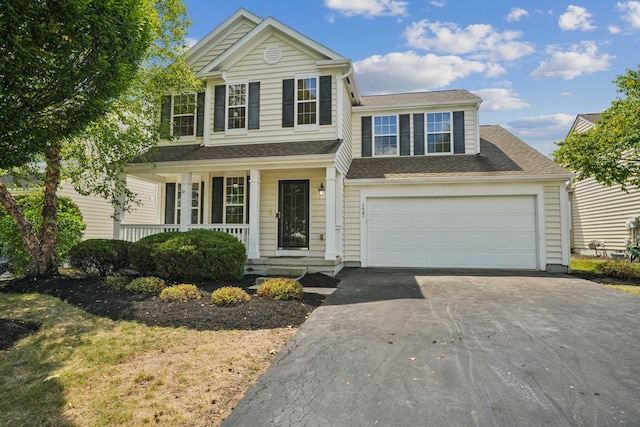 view of front of house featuring a garage and a porch