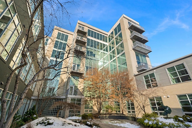 snow covered building with cooling unit