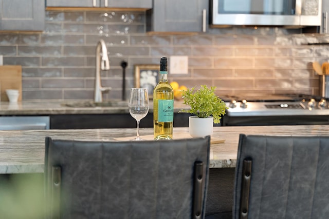 kitchen with backsplash, stainless steel appliances, and sink