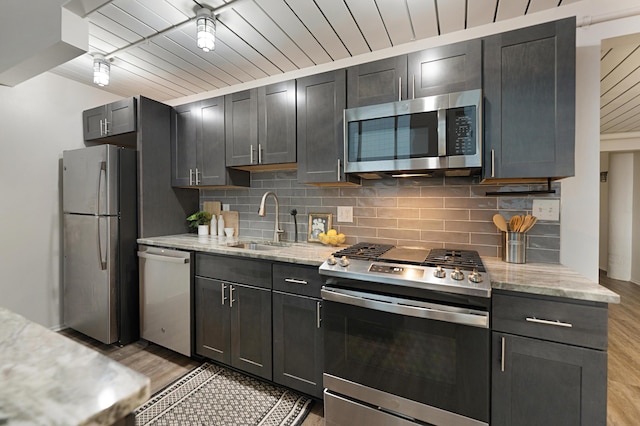 kitchen featuring sink, wood ceiling, stainless steel appliances, and light stone countertops