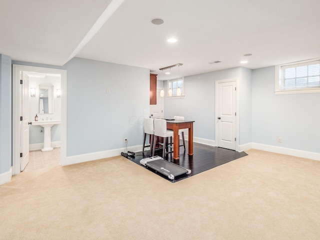 workout area with a healthy amount of sunlight and light colored carpet