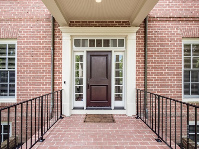 view of exterior entry featuring a balcony