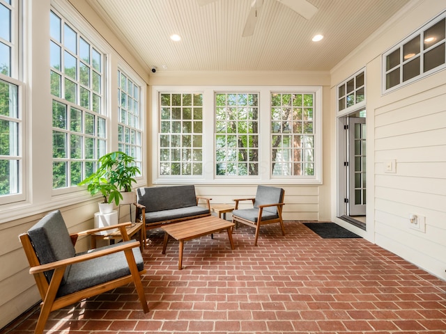 sunroom / solarium featuring ceiling fan