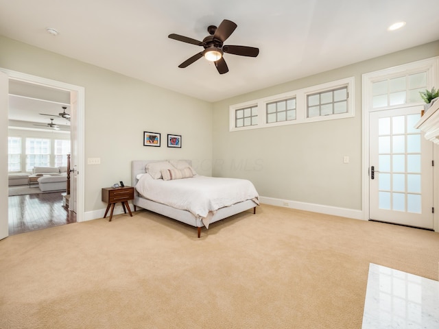 bedroom with ceiling fan and light carpet