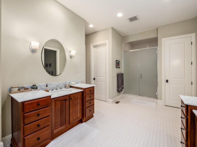 bathroom featuring vanity and a shower with door