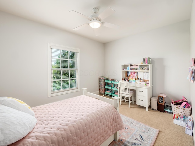 bedroom with ceiling fan and light carpet