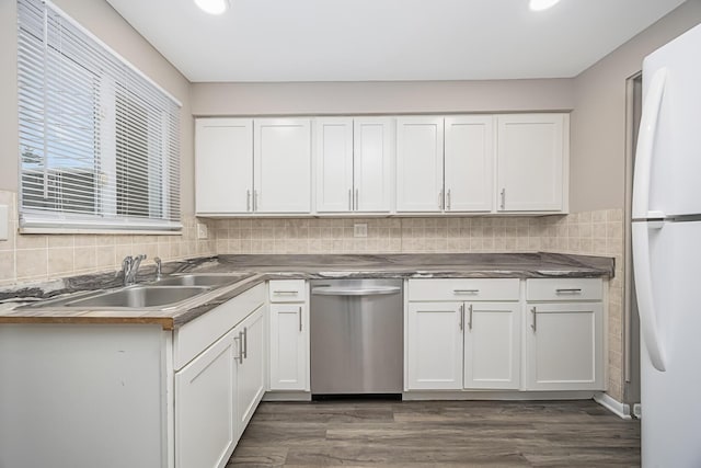 kitchen featuring white fridge, white cabinetry, dishwasher, and sink