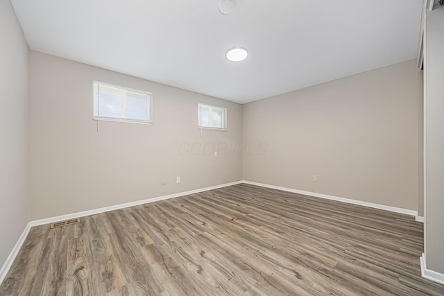 spare room with wood-type flooring