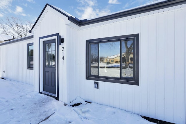 view of snow covered property entrance