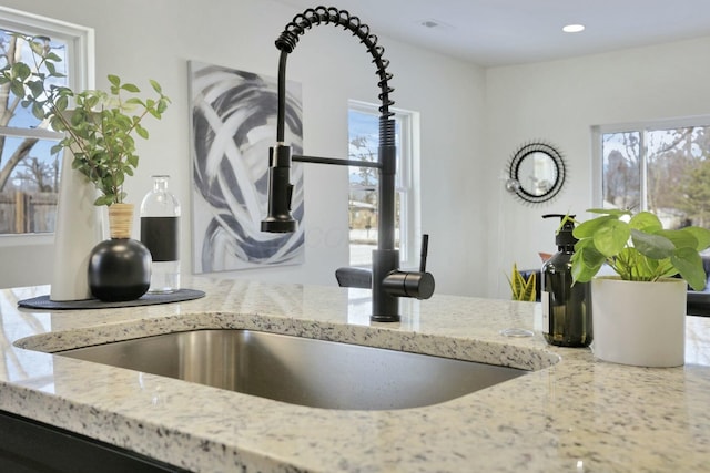 interior details with light stone counters and sink