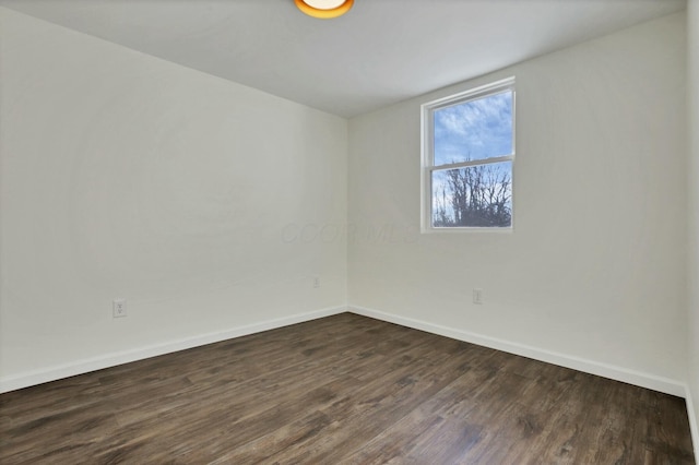 empty room featuring dark wood-type flooring