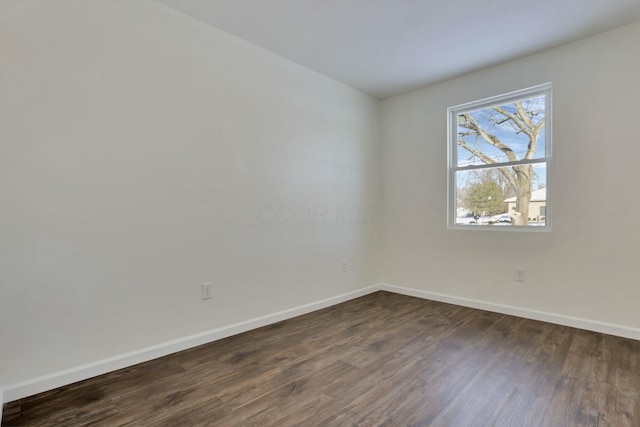 spare room featuring dark hardwood / wood-style floors