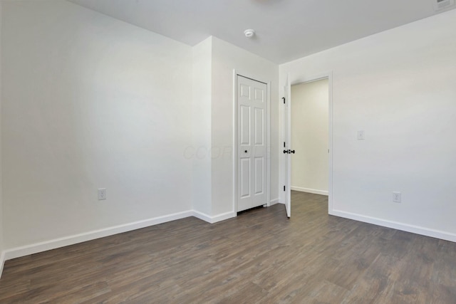 spare room with dark wood-type flooring